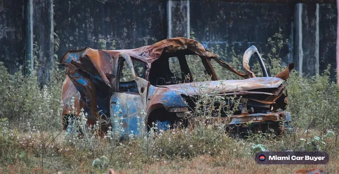 Rusty junk truck sitting in a Miami yard, waiting to be picked up for cash