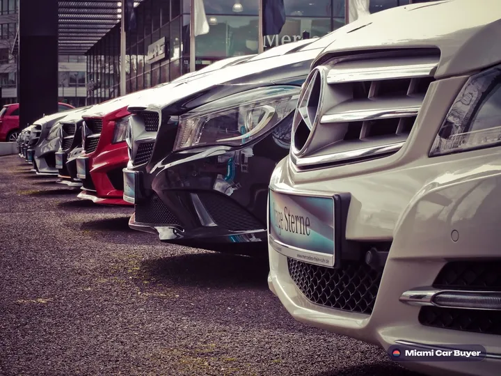 Row of white luxury cars representing the variety of vehicles sold through Miami Car Buyer across Miami-Dade