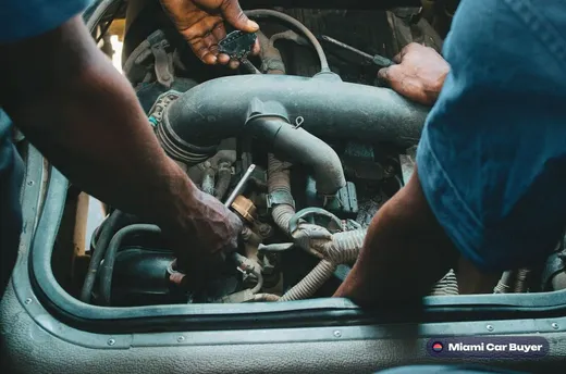 Inspecting a damaged car's remaining parts value during a Miami appraisal