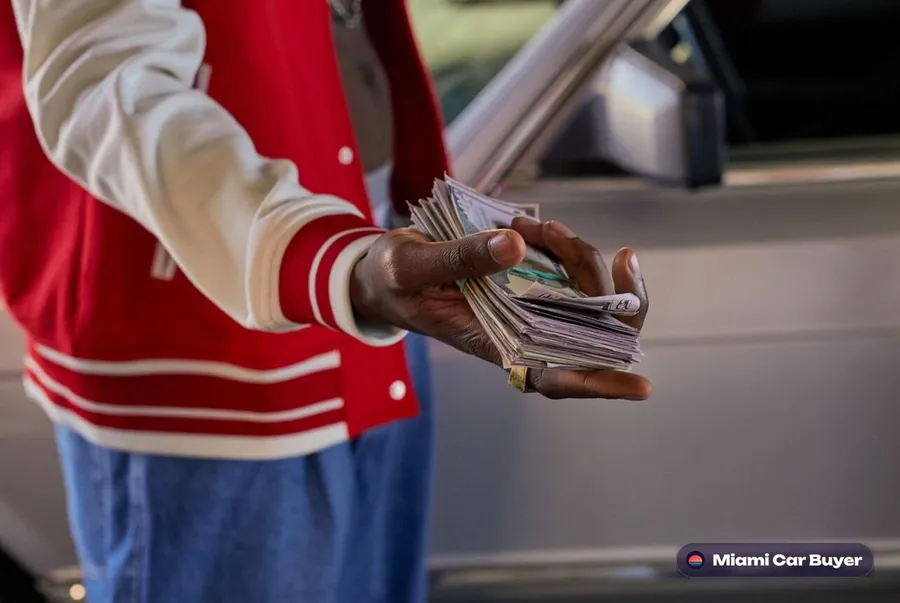 Cash counted out for car keys at a Kendall driveway pickup