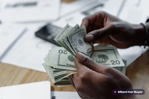 Cash counted into a seller's hand at the moment of a car sale
