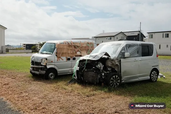 Hurricane-damaged vehicles in a Homestead lot - Miami Car Buyer accepts cars without titles