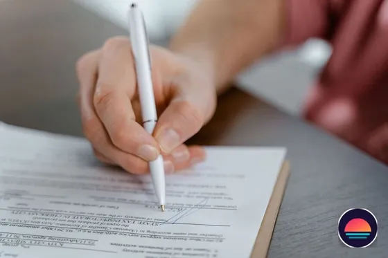 Close-up of a car title document being signed for a licensed dealer transaction in Florida